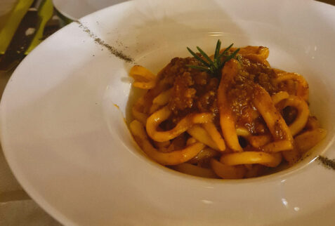 Homemade pici, a typical tuscan type of pasta, with ragù - Osteria del Borgo