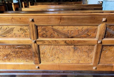 Merano Alto Adige – wooden bench with carved decorations in Chiesa di San Nicolò